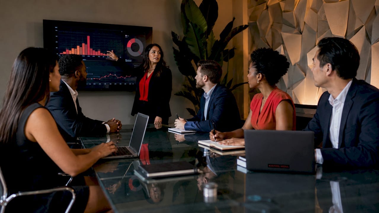 Business team discussing B2B marketing strategy at table