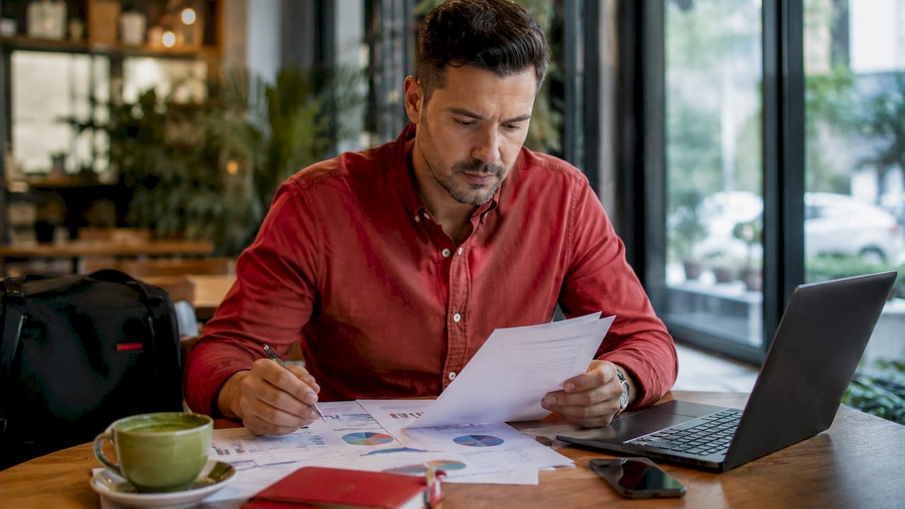 Marketer reviewing advertising strategy reports