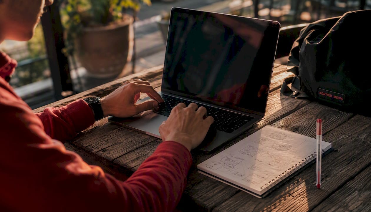 Hands typing laptop in coworking space