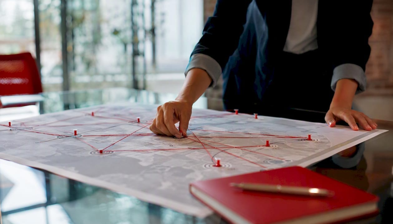 Hands placing pin on strategic account map