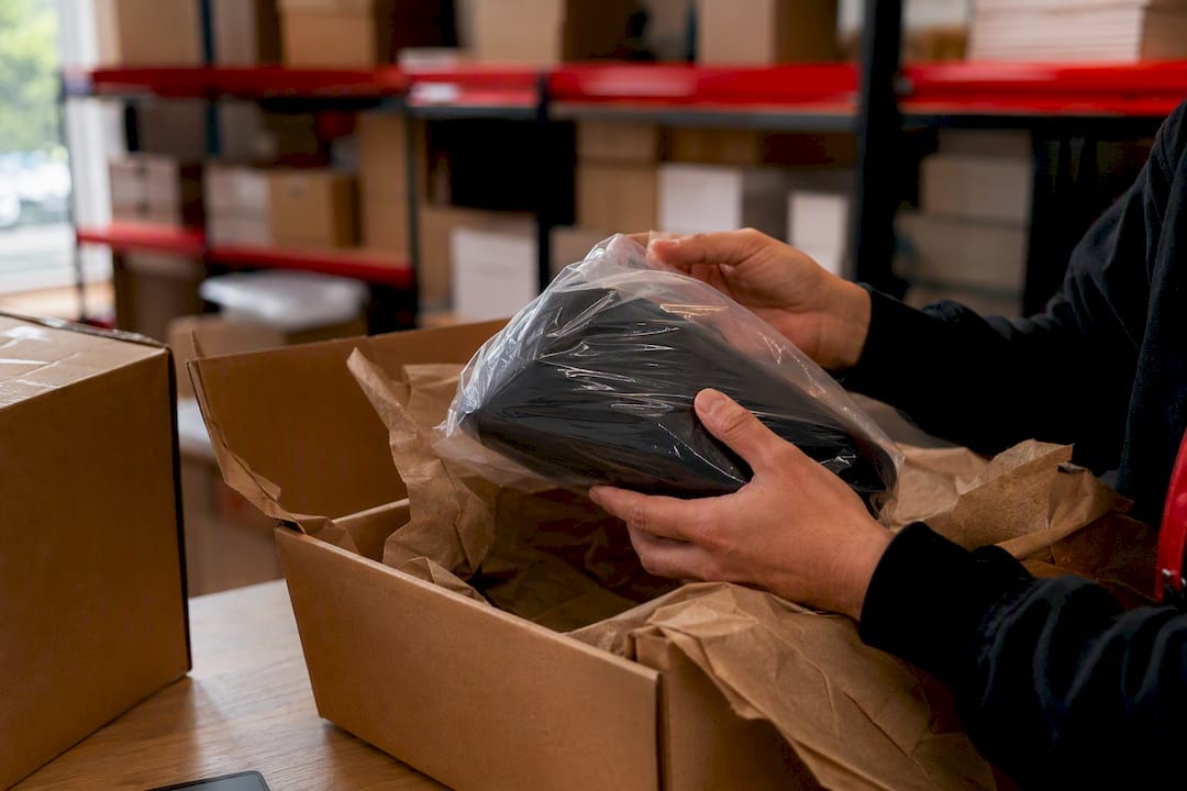 Hands inspecting returned product package