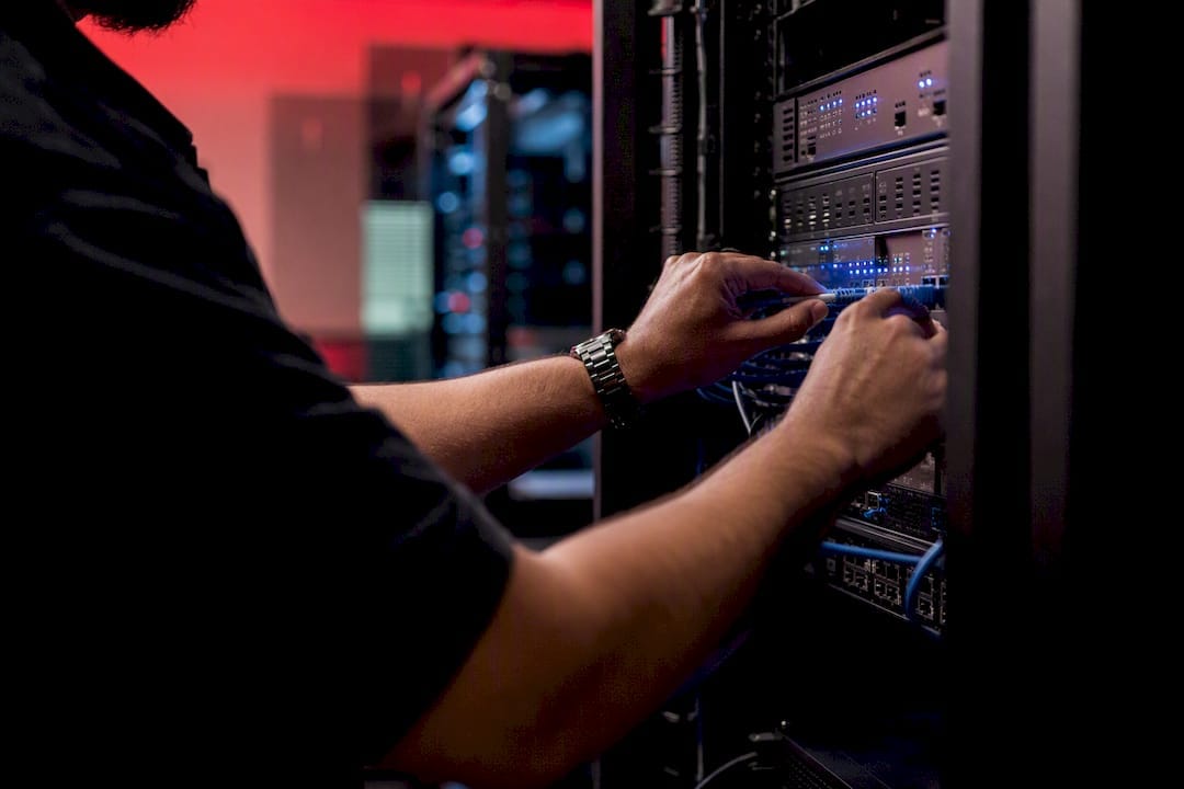 Hands connecting retail media network cables