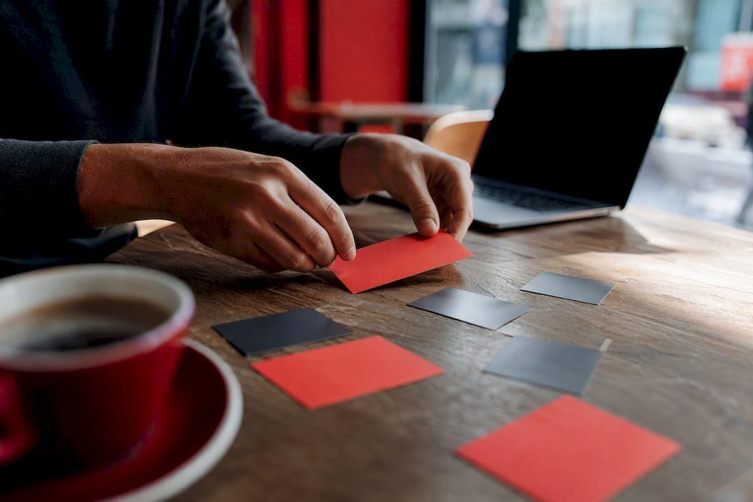 Hands arranging strategy cards on table