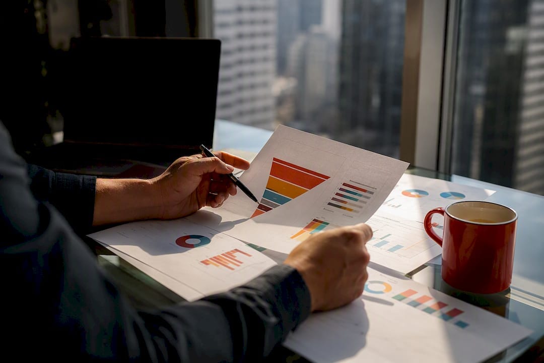 Hands analyzing sales model charts