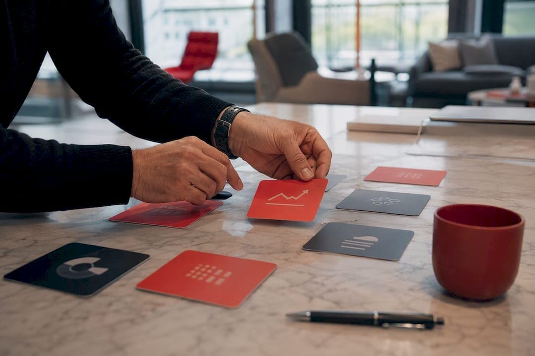 Hands arranging business strategy cards