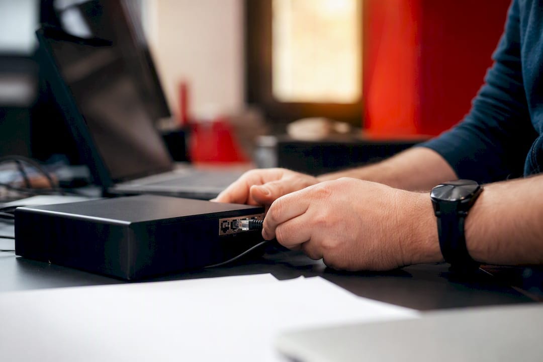 Hands connecting cable in retail media network
