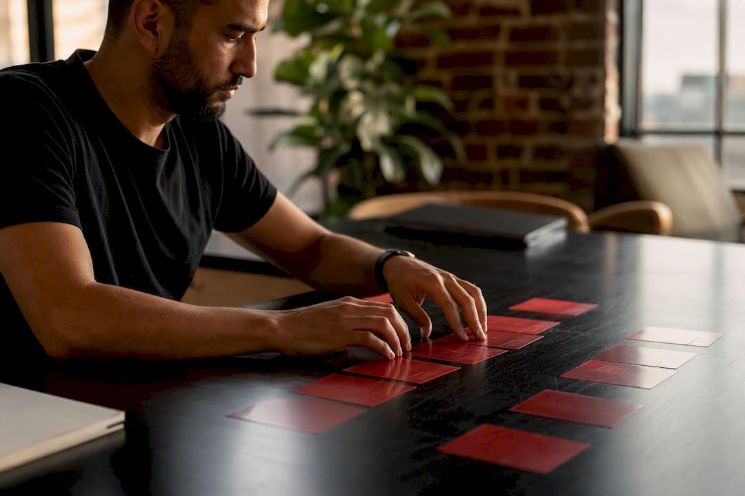 Hands organizing advertiser management cards