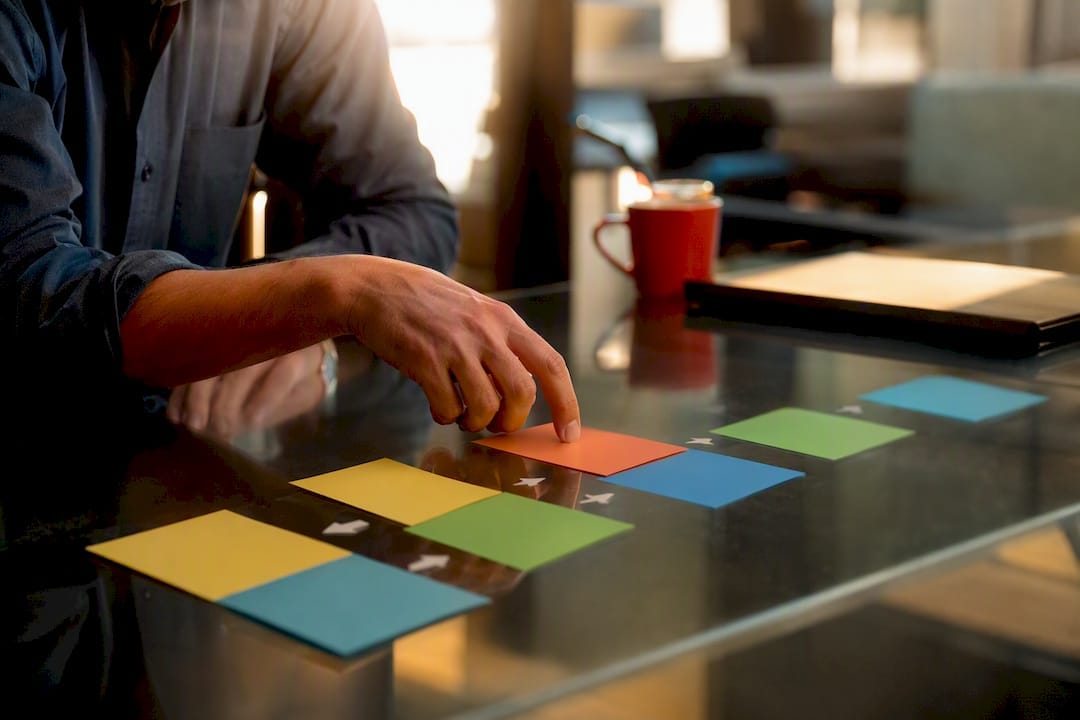 Hand adjusting sales outreach workflow cards