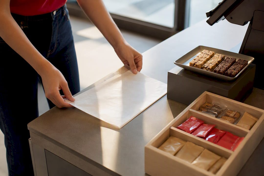 Staff placing insert at campus checkout