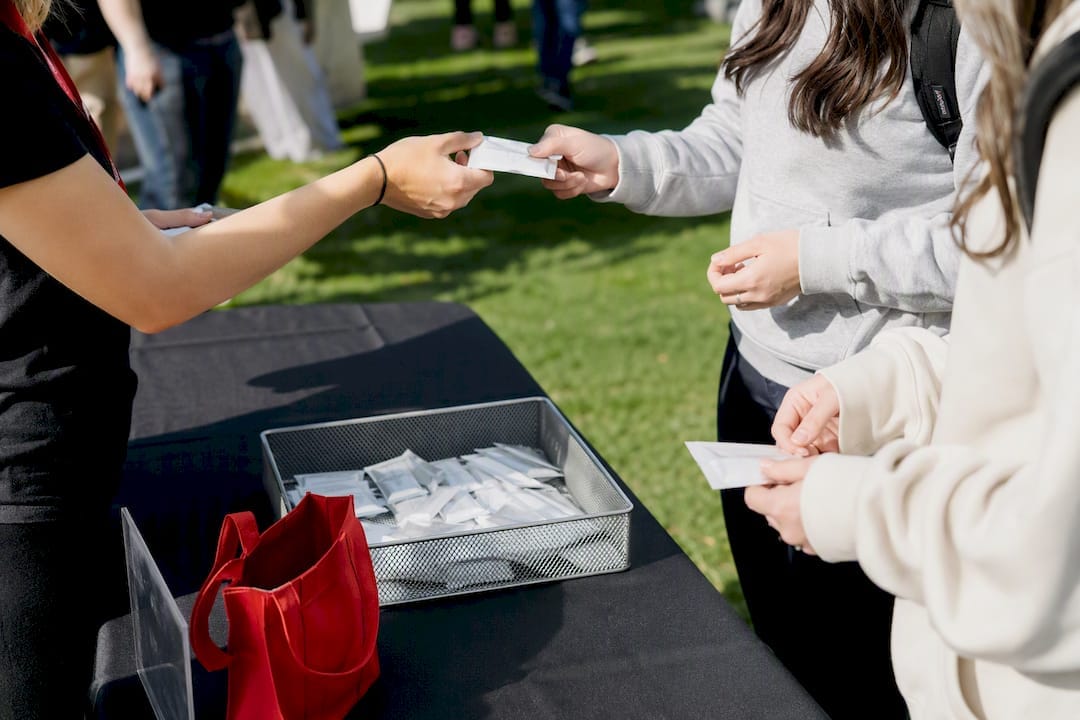 Students receiving samples at campus activation