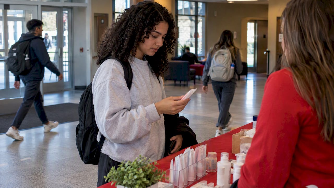 Student exploring skincare samples on campus